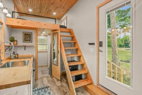 a tiny house with a staircase and a sink at Tiny House hosted by Joe in West Palm Beach