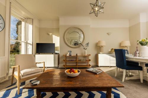 a living room with a bowl of fruit on a wooden table at 24 Montpellier Spa Road in Cheltenham