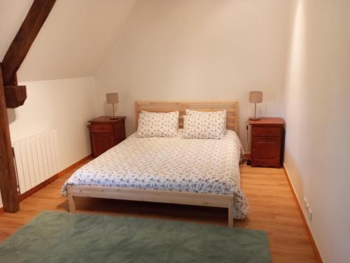a bedroom with a bed and two night stands at La Mancellière de Montjoie chambres d'hôtes et gîtes in Saint-Michel-de-Montjoie