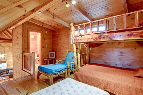 a bedroom with a bunk bed in a cabin at Riverfront Blue Ridge Cabin with Private Hot Tub in Mill Spring