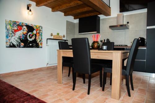 a dining room with a wooden table and black chairs at B & B CA’ D’ OLINA in Pavullo nel Frignano