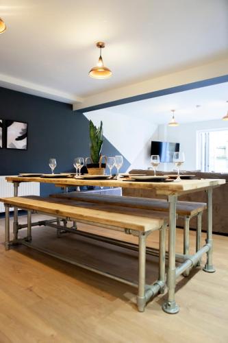 a dining room table with wine glasses on it at Cotswolds-Stroud-Comfy 4 bed house-Sleeps 10-Free Parking-Wifi in Ebley