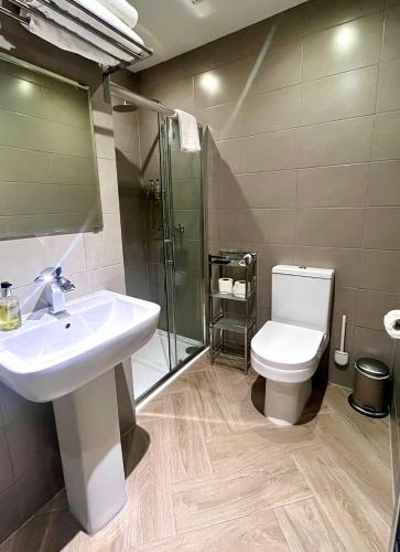 a bathroom with a sink and a toilet at Mode Apartments St Annes in Lytham St Annes