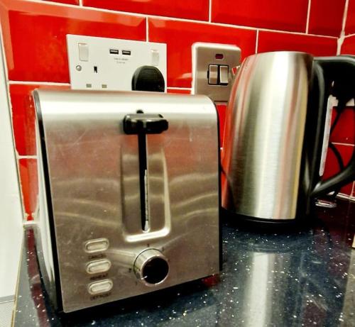 a toaster sitting on top of a kitchen counter at Lovely Studio- Aldgate East Stn in London