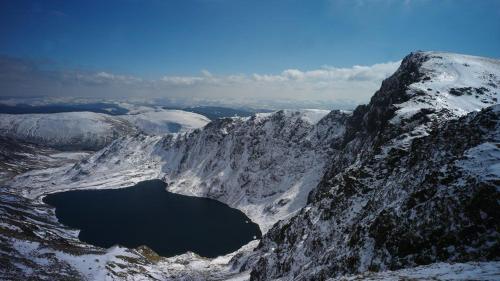 an aerial view of a snowy mountain with a lake at Y Bwthyn Bach Cute Stone Cottage in Tywyn in Tywyn