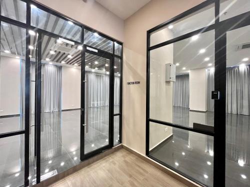 an empty room with glass doors in a building at Cozy 1-4Pax SkyTrees AeonBukitIndah NetflixWifi in Johor Bahru