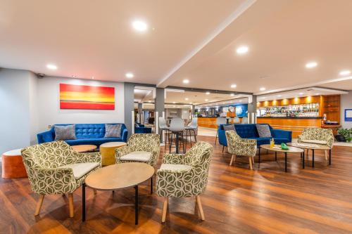 a lobby with a couch and chairs and tables at Holiday Inn Express Ramsgate – Minster by IHG in Ramsgate