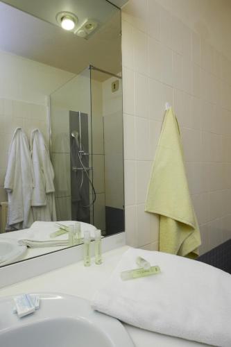 une salle de bain avec un lavabo et un miroir dans l'établissement Residence Les Chenes, à Saint-Paul-lès-Dax