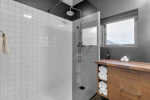 a bathroom with a shower with a glass door at Tindasel Lodge in Hella