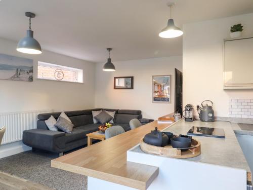 a living room with a couch and a table at Little Haven in Frinton-on-Sea