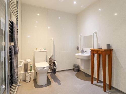 a bathroom with a toilet and a sink at Little Haven in Frinton-on-Sea