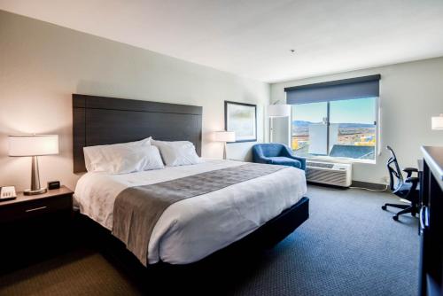 a hotel room with a large bed and a window at Shutters Hotel in Elko