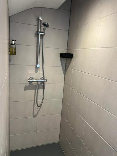 a shower with a shower head in a bathroom at Mode Apartments St Annes in Lytham St Annes