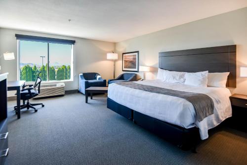 a hotel room with a bed and a desk and chair at Shutters Hotel in Elko