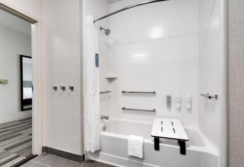 a white bathroom with a bath tub and a sink at Hampton Inn & Suites Ft Worth-Burleson in Burleson