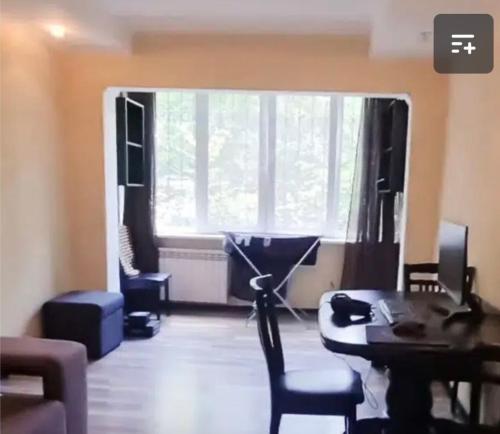 uma sala de estar com uma secretária e uma janela em VIP apart 522 em Tbilisi