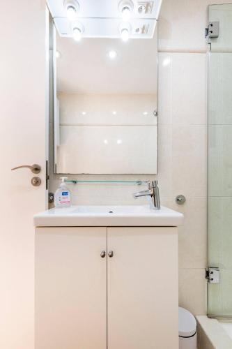 a bathroom with a sink and a mirror at Sitges Seafront RIBERA in Sitges