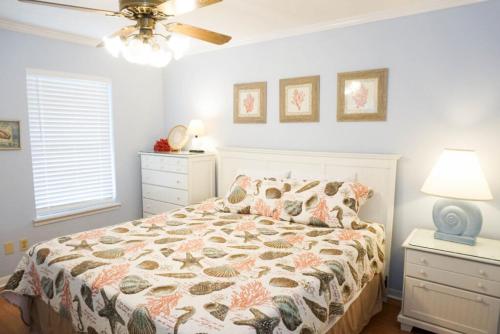 a bedroom with a bed and a ceiling fan at Venture Out 79 Gulf Loop Comes With Golf Cart in Panama City Beach
