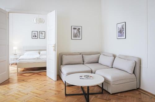 ein Wohnzimmer mit einem Sofa und einem Tisch in der Unterkunft HeyMi Apartments Stephansdom in Wien