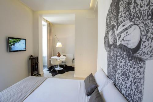 a bedroom with a bed with a picture on the wall at Locanda del Bagatto in Milazzo