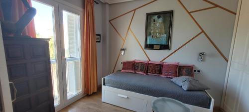 a bedroom with a bed with a geometric headboard at Almerimar Pearl in Almerimar