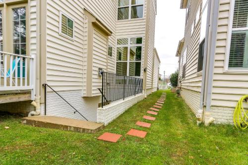a house with a walkway next to a house at Clarksburg Getaway Near DC and Baltimore Sights! in Germantown