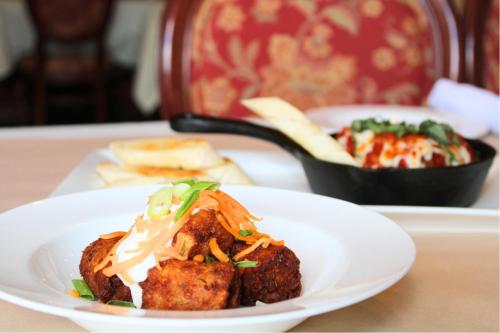 a plate of food on a table with a bowl of food at Monte Carlo Inn & Suites Downtown Markham in Markham