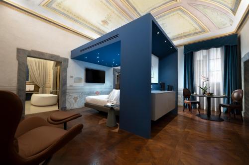a bedroom with a bed with a blue ceiling at Palazzo Giusti Suites and Spa in Urbino