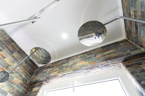 a ceiling with three lights and a brick wall at Cacilhas Riverview! in Almada