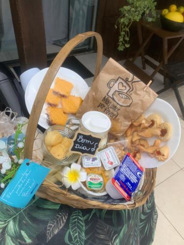 a basket full of food and snacks on a table at Pousada Bravo in Balneário Camboriú