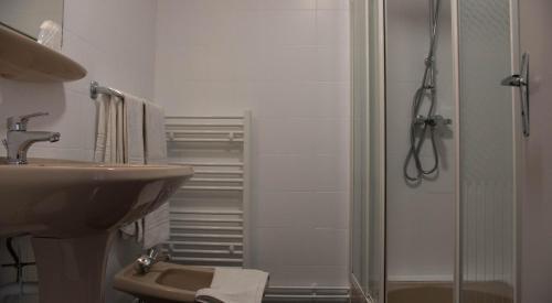 a bathroom with a sink and a shower at Hôtel Des Docks in Digoin