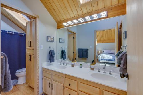 a bathroom with two sinks and a large mirror at Spacious Angel Fire Retreat 3 Mi to Ski Resort in Angel Fire