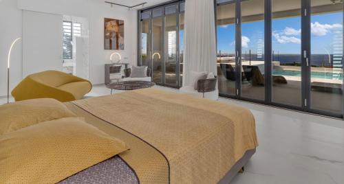 a bedroom with a bed and a view of a pool at Villa Regatta in Kralendijk
