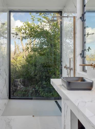 a bathroom with a sink and a large window at Villa Regatta in Kralendijk
