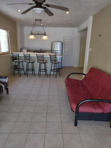 a living room with a couch and a kitchen at Villas Del Mar in Celestún