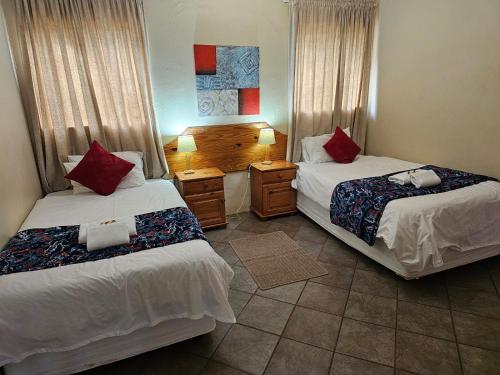a bedroom with two beds and a room with at Leribisi Lodge in Tierpoort