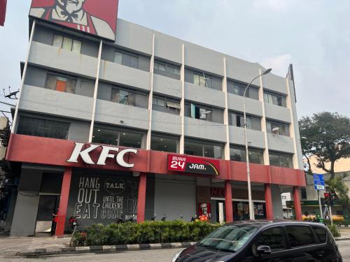 a kfc building with a car parked in front of it at Regalia suites 424 in Kuala Lumpur