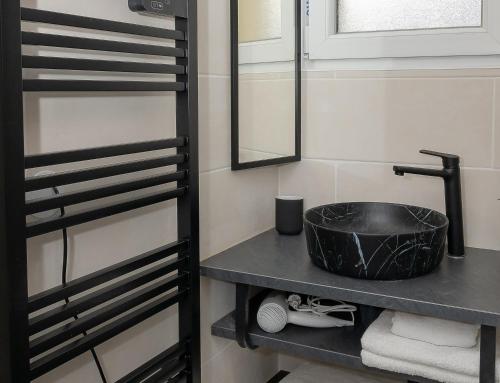 a bathroom with a sink and a mirror at Chalet les Iris in Le Massot