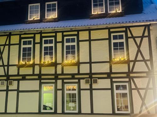 a building with lights in the windows at night at Harzhotel Warnstedter Krug in Thale