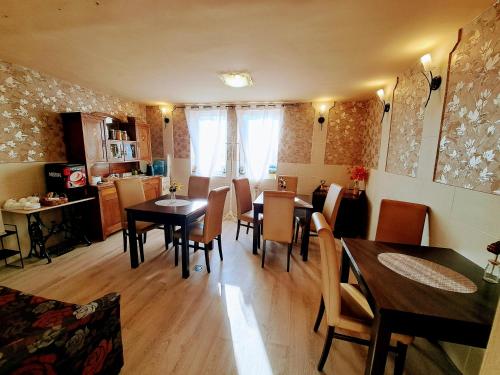 a dining room with a table and chairs at Orient Apartmanház in Eger