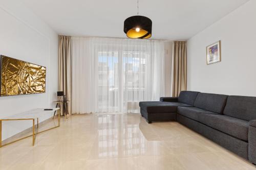 a living room with a couch and a table at LAM Jegeho Alej - JACUZZI - FREE PARKING in Bratislava