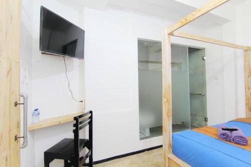 a bedroom with a bunk bed with a flat screen tv at NeoMoritz Homestay in Bandung