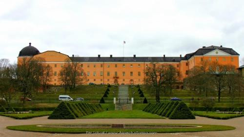 a large building with a garden in front of it at Hotel Charlotte / Stella in Uppsala