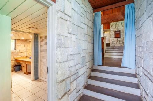 a hallway of a house with a stone wall at Frenchman's Cove Resort in Port Antonio