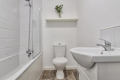 a white bathroom with a toilet and a sink at Deluxe Large Three Room Apartment by Southend Stays in Southend-on-Sea