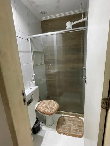 a bathroom with a shower with a toilet and a sink at Água Campos in Campos dos Goytacazes