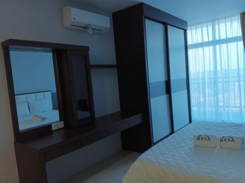 a bedroom with a bed and a large mirror at Formosa Spacious Apartments with Netflix & Pick Up Service by MESA in Nagoya