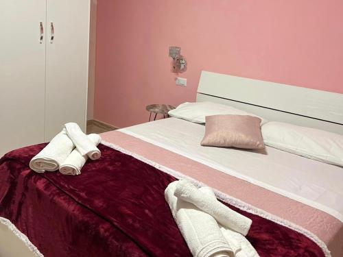 a bedroom with a large bed with towels on it at AL CENTRO in Formia