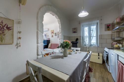 a kitchen and dining room with a table and chairs at Holiday Home Inga with free private parking in Rijeka