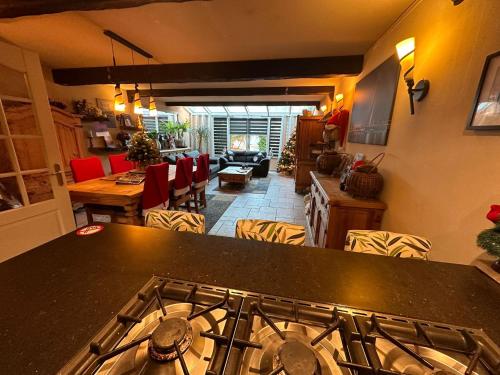 a kitchen with a stove top and a living room at Rotterdam Luxury House in Rotterdam